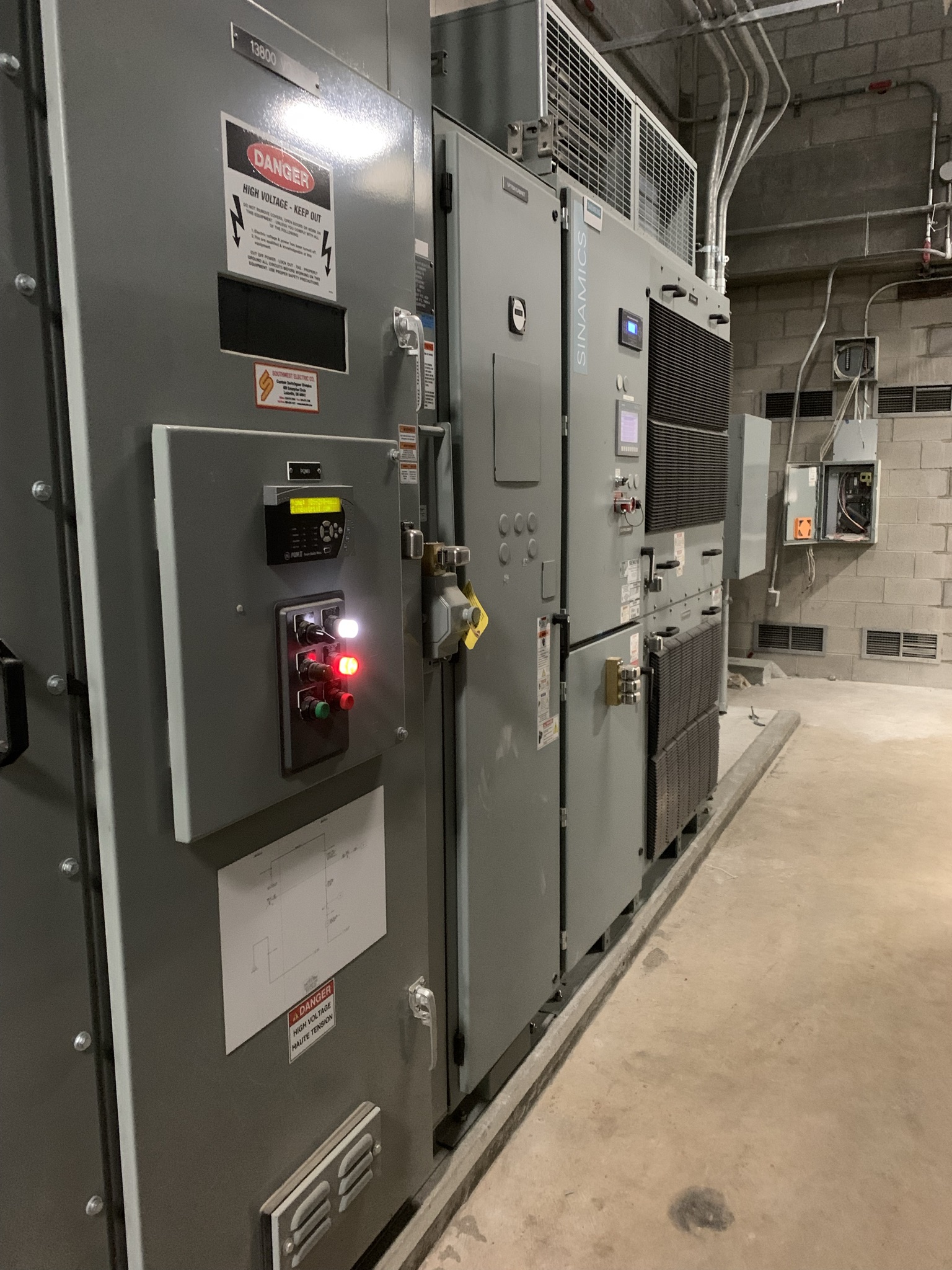 In this picture, you can see the mechanical exterior of the new Variable Frequency Drive, or VFD. A VFD is an electrical device that controls the speed of an electric motor, such as the ones used at our wastewater treatment plant, by varying it's input voltage.